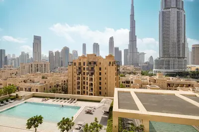 a view of a city skyline with a swimming pool at Lux apartment with full Burj View - 5 min walk to Dubai Mall in Dubai