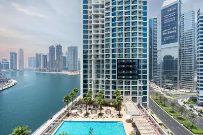an aerial view of a tall building next to a body of water at Luxury Canal-View Studio in Dubai