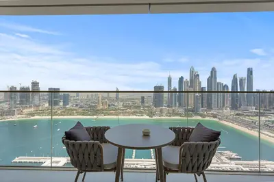 a balcony with a table and chairs and a view of the city at Iconic 3 Bedroom with Panoramic View in Grand Bleu in Dubai