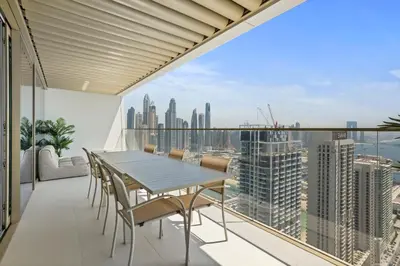 a balcony with a table and chairs and a view of the city at Iconic 3 Bedroom with Panoramic View in Grand Bleu in Dubai