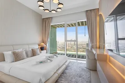a hotel room with a bed and a large window at Iconic 3 Bedroom with Panoramic View in Grand Bleu in Dubai