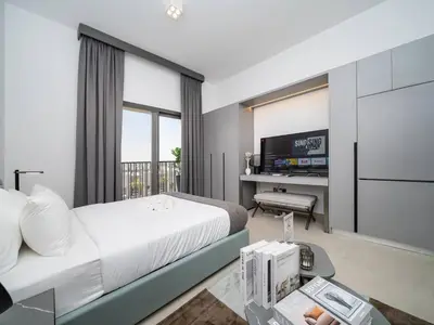 a hotel room with a bed and a television at Contemporary Meydan Studio Escape in Dubai