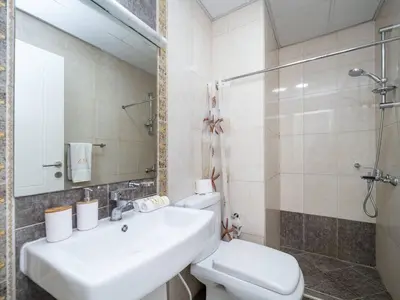 a bathroom with a sink and a toilet and a shower at Spacious 3 Bed Marina Haven with Waterfront Views in Dubai