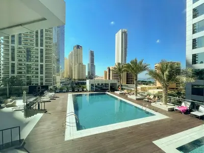 a swimming pool on top of a building with a city at Elegant 1-Bedroom Retreat with Marina Views in Dubai