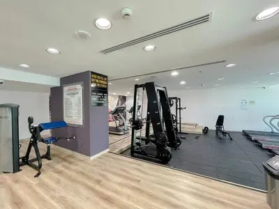 a gym with treadmills and exercise equipment in a room at Elegant 1-Bedroom Retreat with Marina Views in Dubai