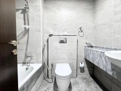a bathroom with a toilet and a sink at Al Manara Classic Deluxe Sheikh Zayed Studio in Dubai