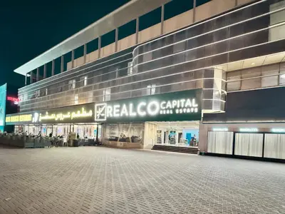 a large building with a sign that reads emerald co central at Al Manara Classic Deluxe Sheikh Zayed Studio in Dubai