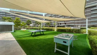 a patio with a ping pong table in a building at Best View Luxury 2BDR Palm Jumeirah, Beach & Pool in Dubai