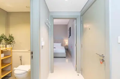 a bathroom with a toilet and a bed in a room at Perfect Location-For Work or Leisure in Dubai