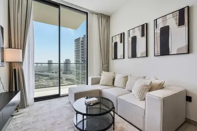 a living room with a couch and a large window at PVH - Elegant 1BR in Binghatti House in Dubai