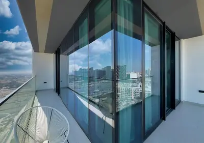 a balcony with a view of a city at Brand New Luxurious 1 BR with Garden, Gym, Pool and Open View in Dubai