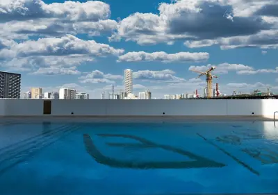a swimming pool with a city skyline in the background at Brand New Luxurious 1 BR with Garden, Gym, Pool and Open View in Dubai