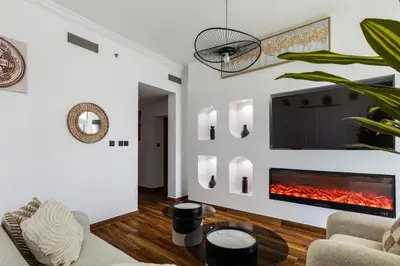 a living room with a fire place in the wall at Luxury Marina View with Jacuzzi, Arcade & Balcony in Dubai
