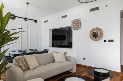 a living room with a couch and a tv at Luxury Marina View with Jacuzzi, Arcade & Balcony in Dubai