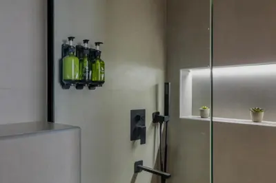 a bathroom with a refrigerator with green bottles on the wall at Luxury Marina View with Jacuzzi, Arcade & Balcony in Dubai