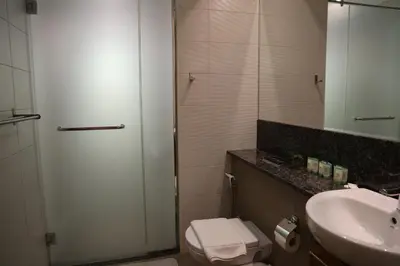 a bathroom with a sink and a toilet and a mirror at Nivis find- Luxury & Spacious 1 BHK 10 mins away from Dubai mall in Dubai