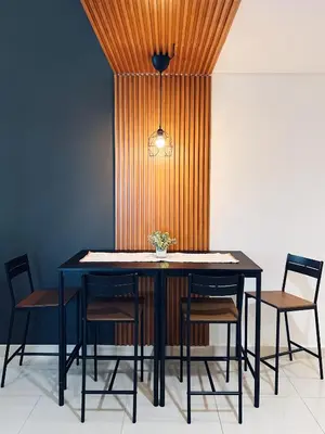 a dining room table with chairs and a ceiling at Dubai Marina Modern 1 Bedroom Apartment - steps to tram & Marina Walk in Dubai