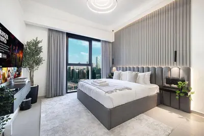 a bedroom with a large bed and a large window at Mahogany 9 - 2BR 10PAX - Walk to Burj & Dubai Mall in Dubai