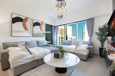 a living room with a couch and a table at Mahogany 9 - 2BR 10PAX - Walk to Burj & Dubai Mall in Dubai