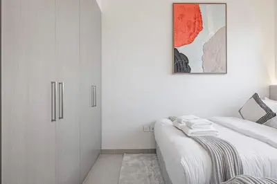 a bedroom with white cabinets and a bed at Mahogany 8 - 4BR 14PAX - Burj Khalifa View Central in Dubai