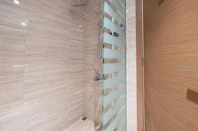 a bathroom with a shower with a glass door at Mahogany 3 - 2BR 6 Guests - Pool & Prime Location in Dubai