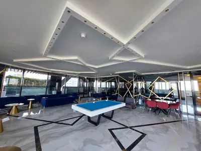 a room with a ping pong table and chairs at Burj Khalifa view studio apartment in Business bay, Downtown in Dubai