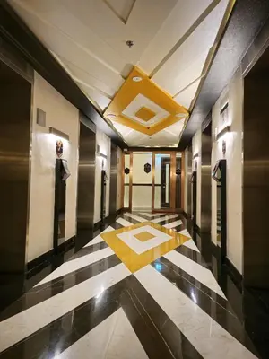 a hallway of a building with black and white tiles at Burj Khalifa view studio apartment in Business bay, Downtown in Dubai