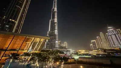 a view of a tall building in a city at night at Elegant Downtown Retreat in Dubai