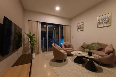 a living room with a couch and chairs and a table at Elegant Downtown Retreat in Dubai