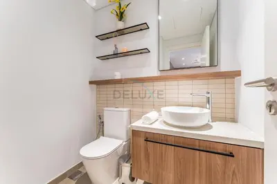 a bathroom with a white toilet and a sink at Brand New Building with Resort-style Amenities, Hamilton House, JVC By Deluxe Holiday Homes in Dubai