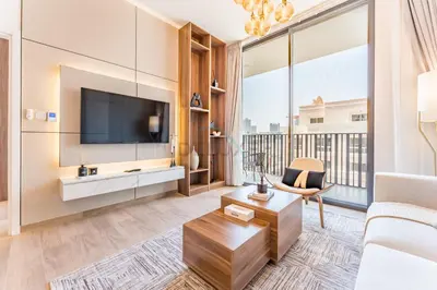 a living room with a tv and a large window at Brand New Building with Resort-style Amenities, Hamilton House, JVC By Deluxe Holiday Homes in Dubai