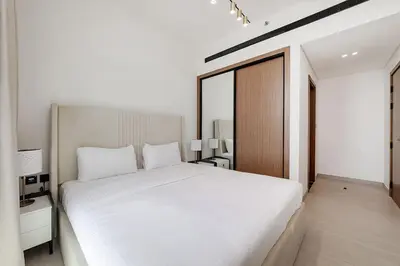 a bedroom with a large white bed in a room at Cozy 1BR apartment in Binghatti Venus JVC in Dubai