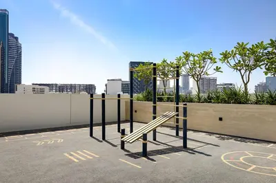 a bench in a parking lot in a city at Cozy 1BR apartment in Binghatti Venus JVC in Dubai