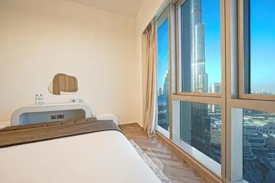 a bedroom with a bed and a large window at Grande Signature Residences Luxury 3BR - Burj View in Dubai Downtown in Dubai