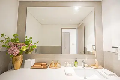 a bathroom with a sink and a large mirror at Grande Signature Residences Luxury 3BR - Burj View in Dubai Downtown in Dubai