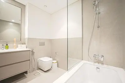 a bathroom with a tub and a toilet and a shower at Grande Signature Residences Luxury 3BR - Burj View in Dubai Downtown in Dubai