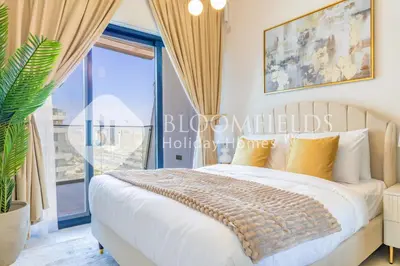 a bedroom with a bed and a large window at Bloomfields Cozy 1Br In Binghatti Creek in Dubai