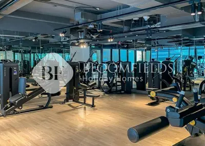 a gym with treadmills and cardio equipment in a building at Bloomfields Cozy 1Br In Binghatti Creek in Dubai