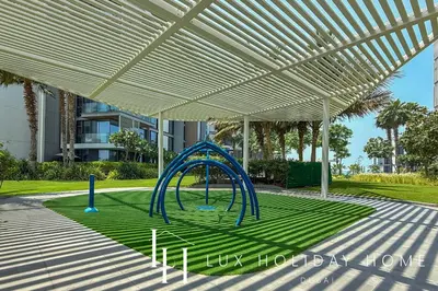 a playground in a park under a white canopy at LUX The Bluewaters Island Suite 2 in Dubai