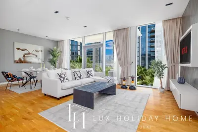 a living room with a couch and a table at LUX The Bluewaters Island Suite 2 in Dubai