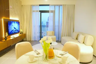 a living room with a couch and a table with flowers at Comfortable 2BR Stay with Sea View in Dubai