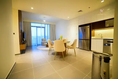 a kitchen and dining room with a table and chairs at Comfortable 2BR Stay with Sea View in Dubai