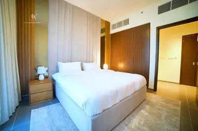 a bedroom with a large white bed in a room at Comfortable 2BR Stay with Sea View in Dubai