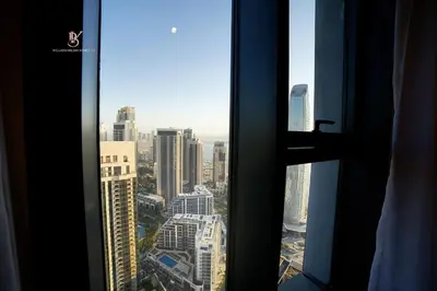 a view of a city skyline from a window at Comfortable 2BR Stay with Sea View in Dubai