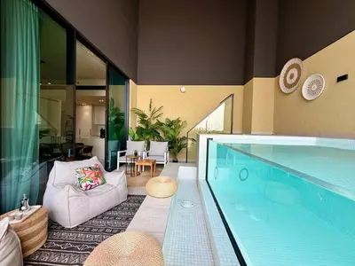 a living room with a large swimming pool at BLVD - Luxe Retreat - Stylish Stay with Full Privacy in Dubai