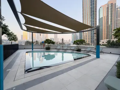 a swimming pool on the roof of a building at Grande Signature Burj Khalifa and Fountain View 2BD Apartment 35th Floor in Dubai