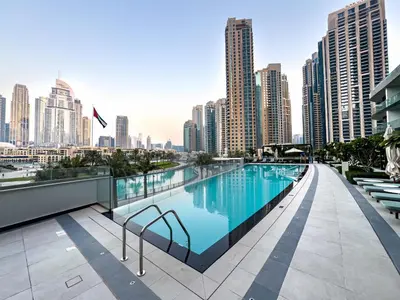 a swimming pool on the roof of a building with a city skyline at Grande Signature Burj Khalifa and Fountain View 2BD Apartment 35th Floor in Dubai
