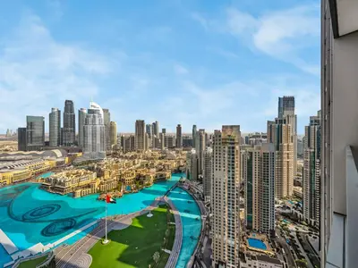 a view of a city with a river and buildings at Grande Signature Burj Khalifa and Fountain View 2BD Apartment 35th Floor in Dubai