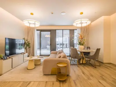 a living room with a couch and a table at TRPS - Ahad Residences, Business Bay - 1BR Luxurious Apartment - Massive Balcony with Pool View in Dubai