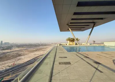 a view from the roof of a building with a swimming pool at Granduer 1 BR in Windsor Manor Canal Front Living With Burj Views in Dubai